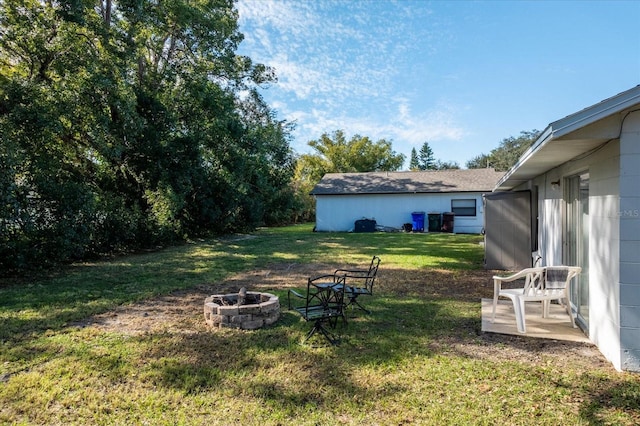 view of yard with an outdoor fire pit