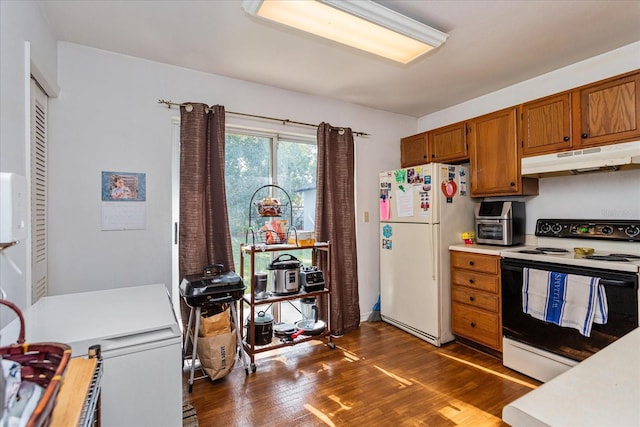 kitchen featuring dark hardwood / wood-style floors and white appliances