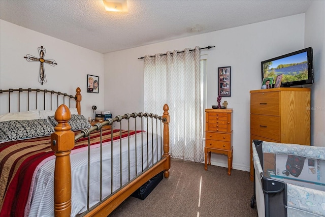 carpeted bedroom featuring a textured ceiling