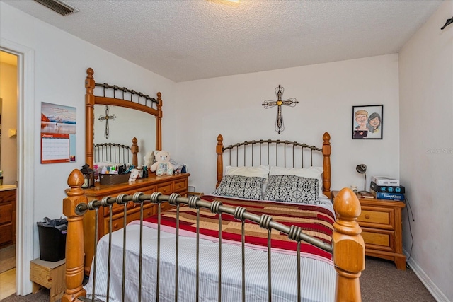 carpeted bedroom featuring a textured ceiling