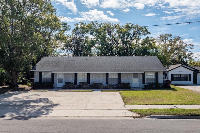 ranch-style home with a front lawn