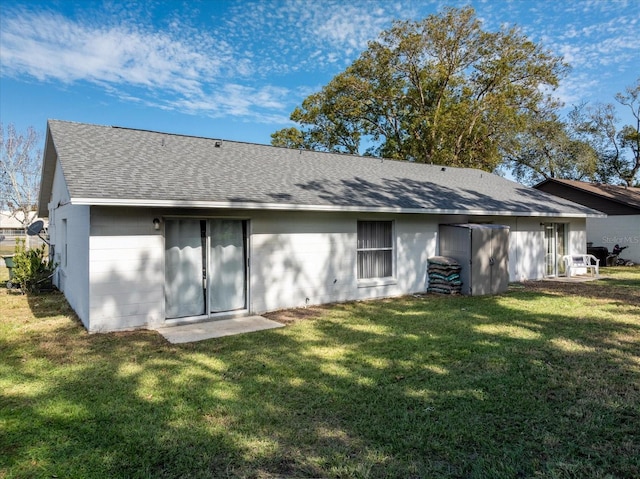 back of property featuring a yard