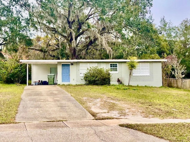 single story home with a front yard and a carport