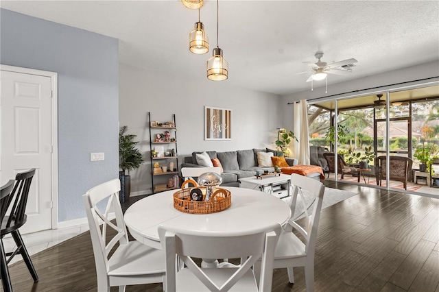 dining space featuring ceiling fan, a textured ceiling, and dark hardwood / wood-style floors