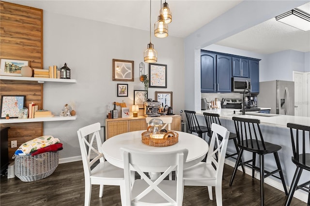 dining area with dark hardwood / wood-style floors and sink