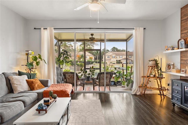 living room featuring ceiling fan and dark hardwood / wood-style flooring