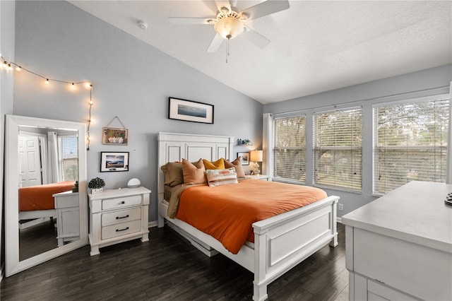 bedroom featuring dark wood-type flooring, ceiling fan, lofted ceiling, and multiple windows