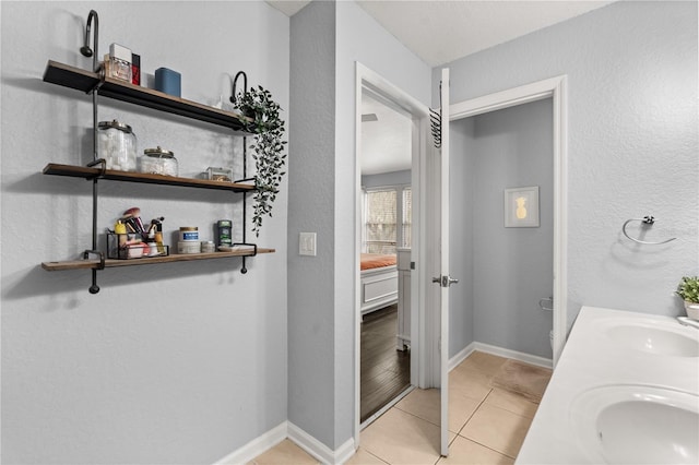 bathroom featuring toilet, tile patterned flooring, and vanity