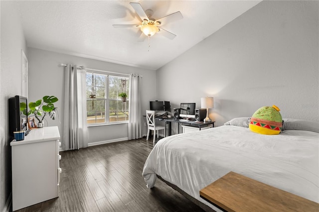 bedroom with vaulted ceiling, ceiling fan, and dark hardwood / wood-style flooring