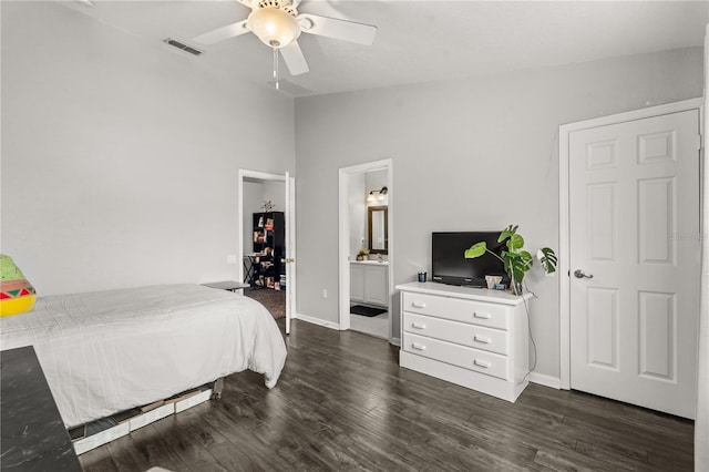 bedroom with ceiling fan, ensuite bathroom, dark hardwood / wood-style floors, and lofted ceiling