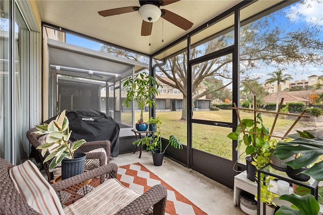 sunroom / solarium featuring ceiling fan