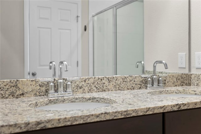 bathroom with vanity and a shower with door