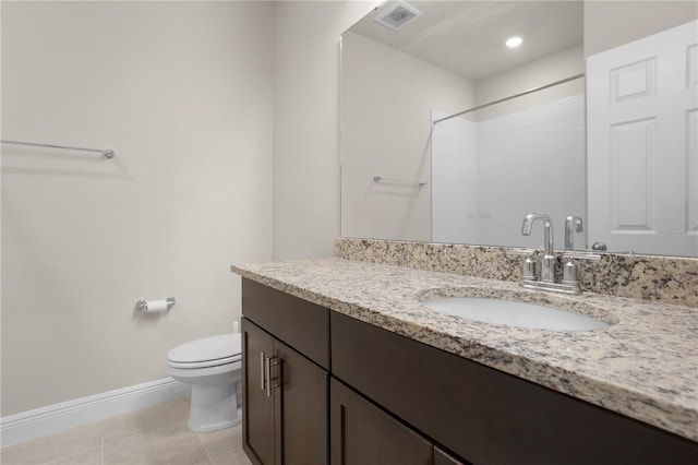 bathroom featuring vanity, walk in shower, tile patterned floors, and toilet