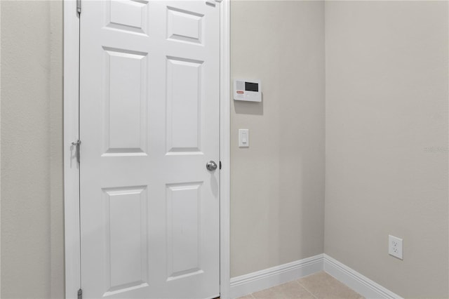 laundry area with light tile patterned floors