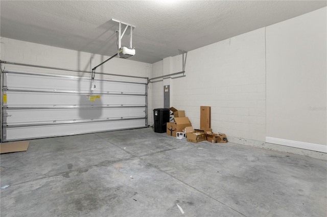 garage with a garage door opener and electric panel