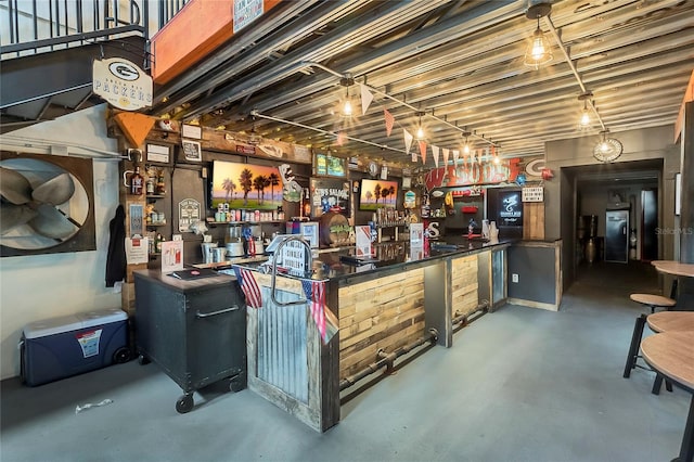 bar with concrete floors and fridge