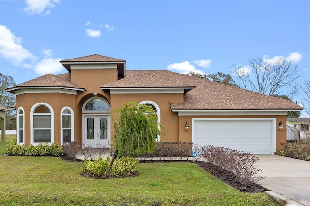 mediterranean / spanish home with a garage and a front lawn