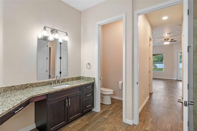 bathroom featuring vanity, ceiling fan, and toilet