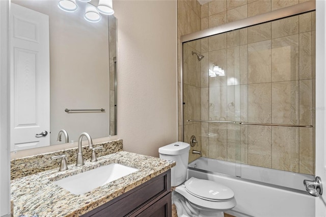 full bathroom with toilet, vanity, and shower / bath combination with glass door