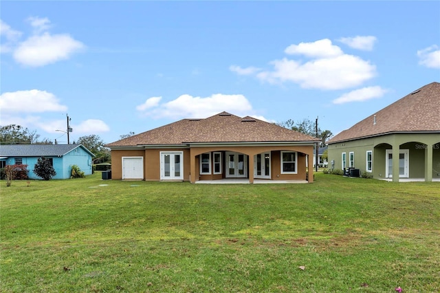 back of house featuring french doors, a yard, a patio, and central air condition unit