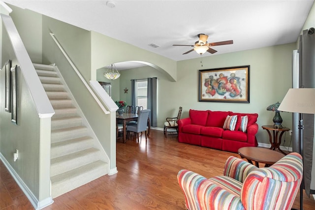 living room featuring hardwood / wood-style floors and ceiling fan