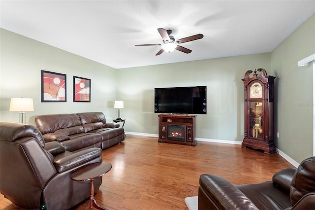 living room featuring hardwood / wood-style flooring and ceiling fan