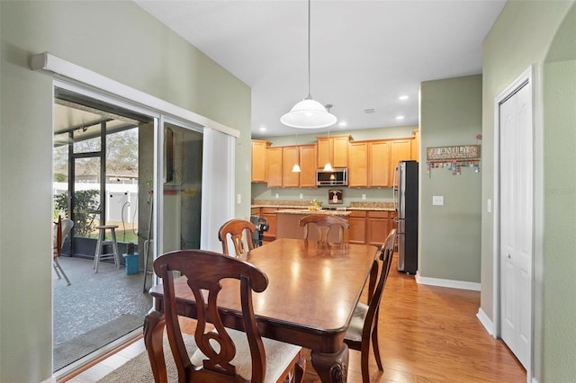 dining area with light hardwood / wood-style flooring