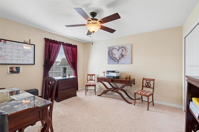 carpeted home office with ceiling fan