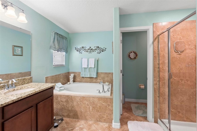 bathroom featuring vanity, tile patterned floors, separate shower and tub, and a textured ceiling