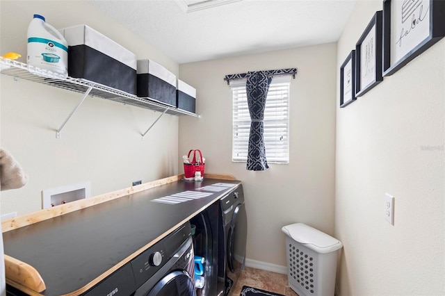 laundry room featuring washer and clothes dryer and a textured ceiling