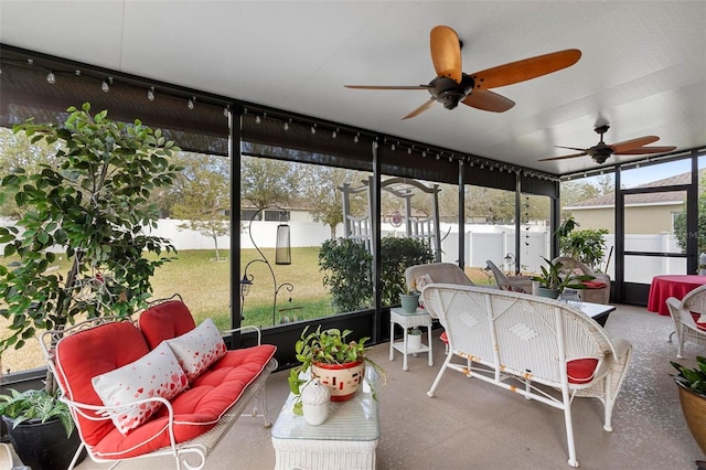 sunroom featuring ceiling fan