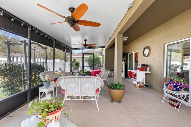 sunroom / solarium featuring ceiling fan and a wealth of natural light