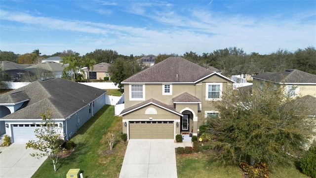 view of front property featuring a garage and a front yard