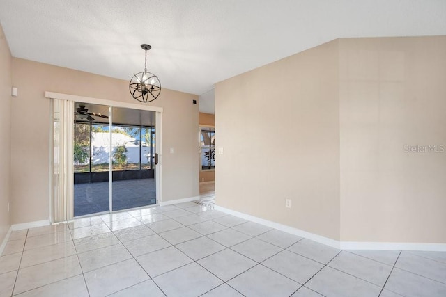 unfurnished room with light tile patterned floors and a chandelier