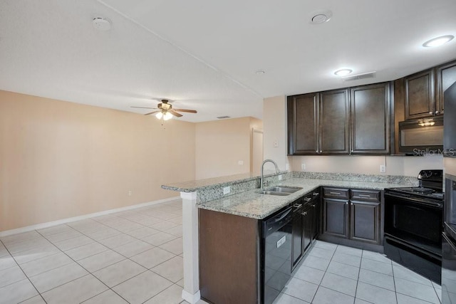 kitchen with light stone countertops, black appliances, sink, kitchen peninsula, and light tile patterned floors