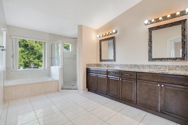 bathroom featuring vaulted ceiling, vanity, independent shower and bath, and tile patterned flooring