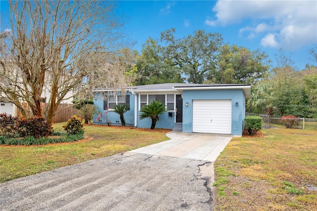 ranch-style home with a garage and a front lawn