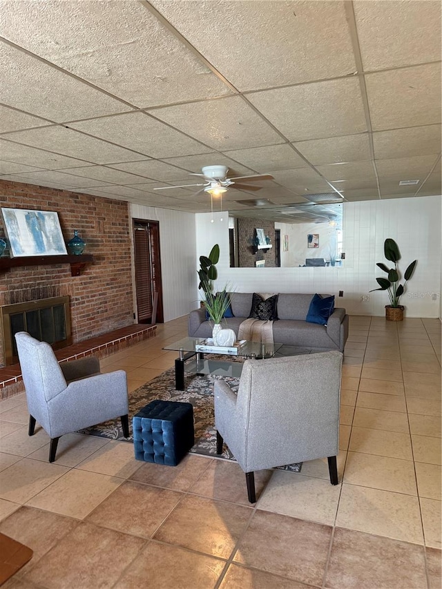 living room featuring light tile patterned floors and a paneled ceiling