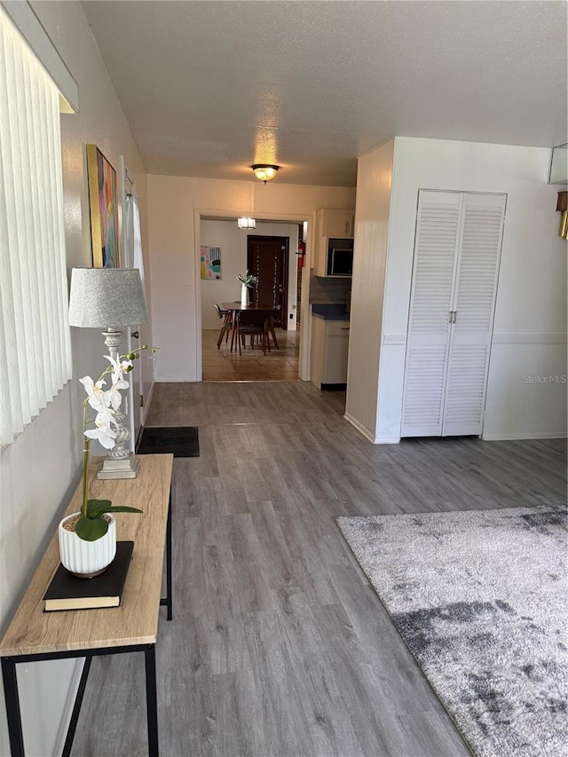 living room with a textured ceiling and wood finished floors