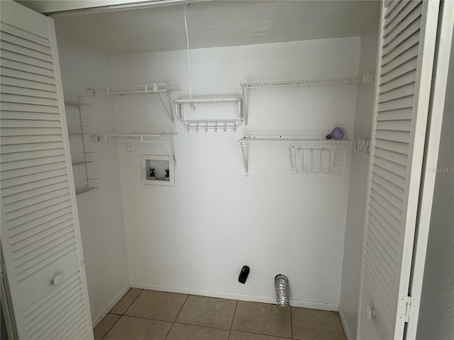 clothes washing area with tile patterned flooring and washer hookup