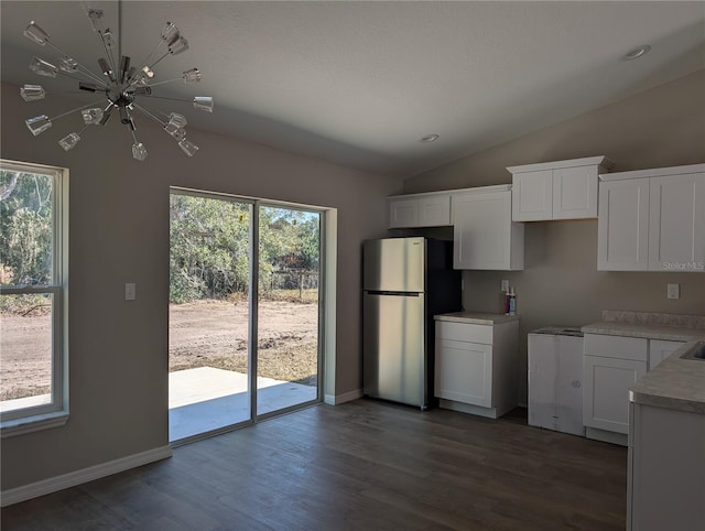 kitchen featuring white cabinetry, dark hardwood / wood-style floors, an inviting chandelier, and stainless steel refrigerator