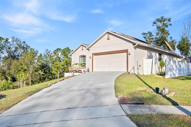 ranch-style house featuring a garage and a front yard