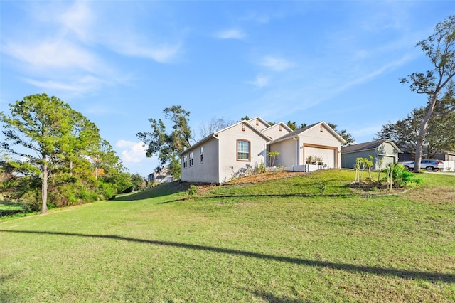 view of front facade featuring a garage and a front lawn