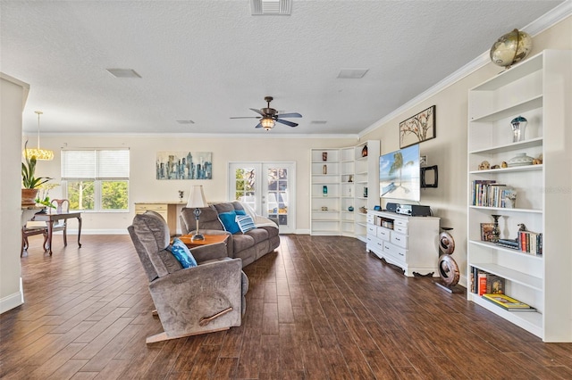 living room featuring crown molding, a textured ceiling, dark hardwood / wood-style flooring, built in shelves, and french doors