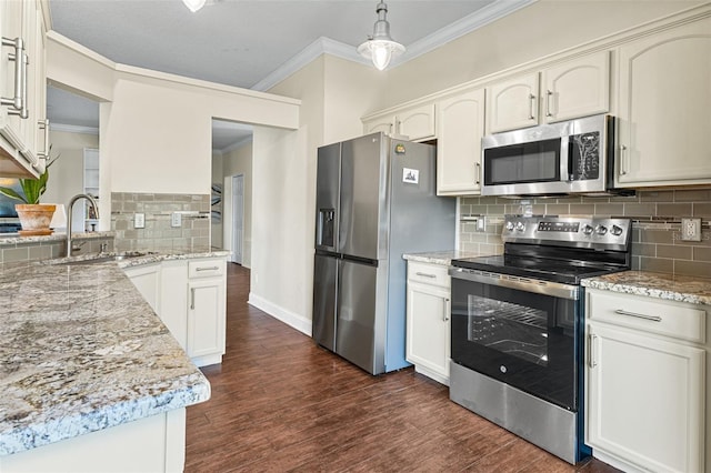 kitchen featuring sink, decorative light fixtures, ornamental molding, appliances with stainless steel finishes, and dark hardwood / wood-style flooring