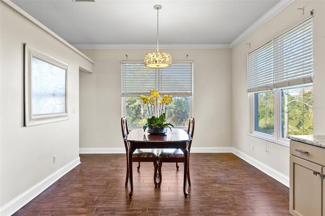 dining room with ornamental molding, plenty of natural light, and dark hardwood / wood-style floors