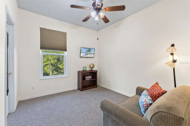 sitting room featuring light colored carpet and ceiling fan