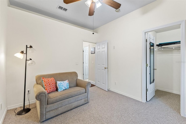 sitting room with light colored carpet and ceiling fan