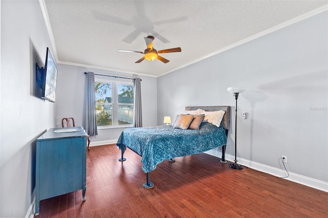 bedroom featuring ornamental molding, dark wood-type flooring, and a textured ceiling