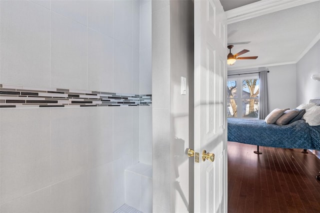 bathroom with ceiling fan, ornamental molding, and wood-type flooring